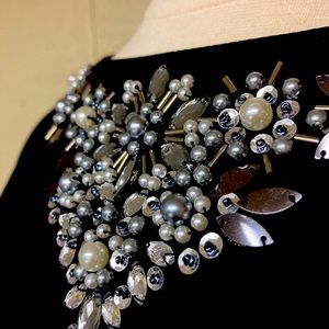 Beautifully decorated black top.